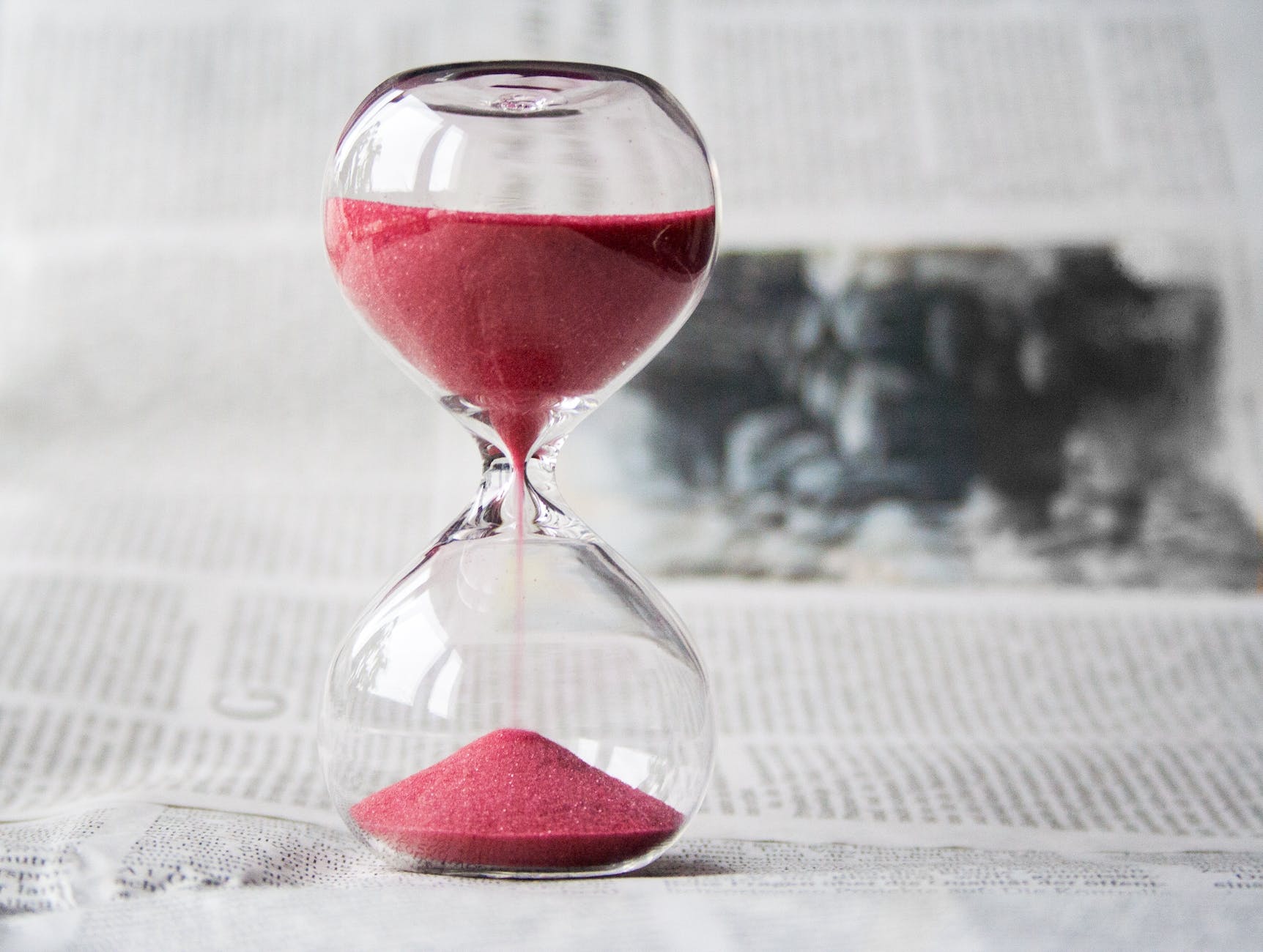 clear glass with red sand grainer- managing time management skills. 